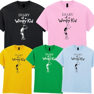 May include: Five short-sleeved t-shirts in black, pink, yellow, green, and light blue. Each shirt displays the text "DIARY of a Wimpy Kid" above a black and white cartoon illustration of a character.