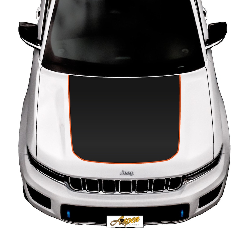 May include: A white Jeep with a black hood wrap featuring an orange stripe. The Jeep has a black grille with the word "Jeep" in silver lettering.