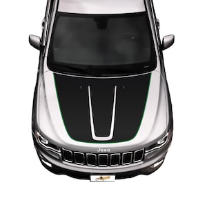 May include: A silver Jeep with a black and green hood decal. The decal has two black stripes with a white stripe in the center. The Jeep has a black grille with the word "Jeep" in white letters.