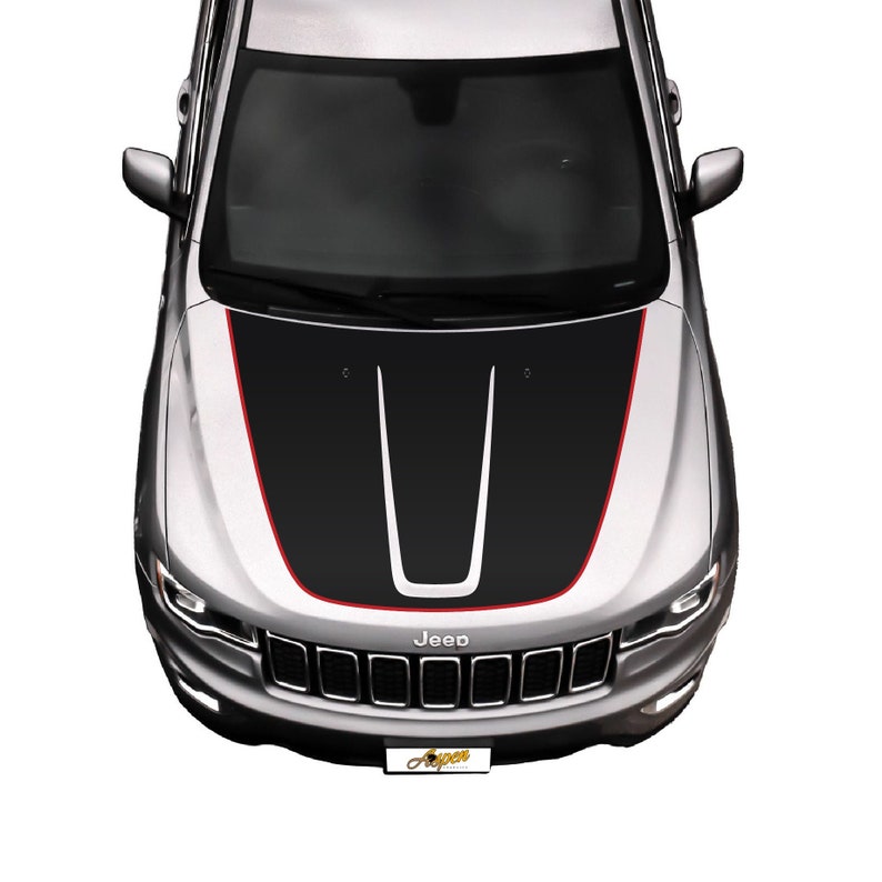 May include: A silver Jeep with a black and red hood decal. The decal has a black stripe down the center with two white stripes on either side. The Jeep has a black grille with the word "Jeep" in white letters.
