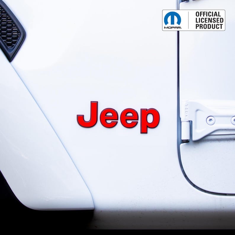 May include: White vehicle door with the red word "Jeep" and a black outline. The Mopar logo and the text "OFFICIAL LICENSED PRODUCT" are in the upper right corner. The door has a black trim and a silver hinge.