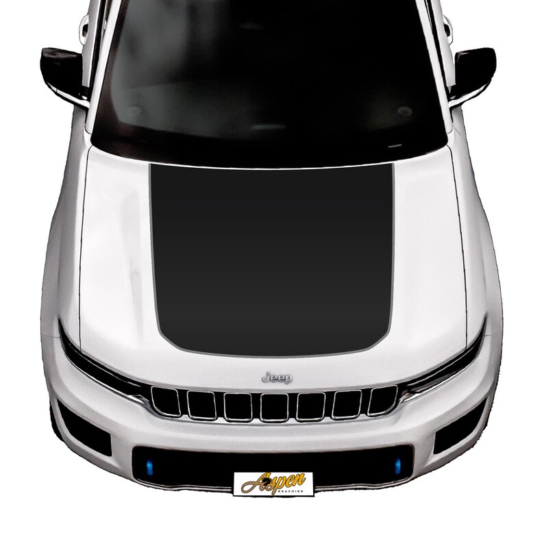 May include: A white Jeep with a black hood decal. The decal has a black stripe down the centre and two smaller stripes on either side. The Jeep has a black grille with the word "Jeep" in silver lettering.