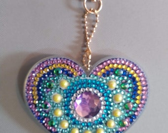 Completed diamond painting heart keychain with maze on back