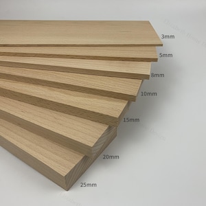 May include: A set of six wooden boards in various thicknesses, ranging from 3mm to 25mm. The boards are arranged in a staggered pattern, with the thickest board at the bottom and the thinnest board at the top.