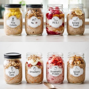 May include: Eight glass jars filled with various overnight oats recipes. Each jar has a black lid and a white label with text and illustrations. Flavors include Pina Colada, PB&J, Banana Bread, Carrot Cake, Strawberry, and Spiced Pear.