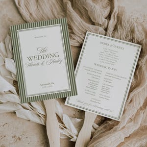 May include: Two wedding fan programs with sage green striped borders and wooden handles. One fan reads "Welcome to The Wedding Thomas & Ansley" and the other lists the order of events and wedding party details.