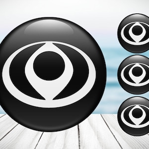 May include: Four black round buttons with a white stylized eye symbol in the centre. The buttons are arranged in a square shape.