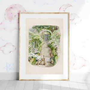 May include: A framed illustration of Peter Rabbit and his siblings walking down a path in a garden. The illustration is in a watercolor style and features a light brown background.