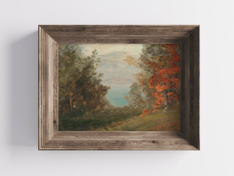 May include: A framed painting of a landscape scene with a lake in the distance, surrounded by trees. The trees on the right side of the painting have red leaves.