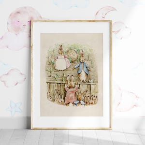 May include: A vintage illustration of Peter Rabbit and his family, featuring a brown rabbit in a blue jacket, a brown rabbit in a pink dress, and a brown rabbit with a white and brown spotted shell. The rabbits are standing in front of a wooden fence with green vines and flowers.