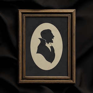 May include: A rectangular wooden frame with a dark brown finish containing a cream-colored oval insert. Inside the oval is a black silhouette profile of a person with a high collar and an open mouth, presented in a classic portrait style.