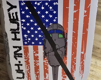 UH-1N Huey over distressed American Flag