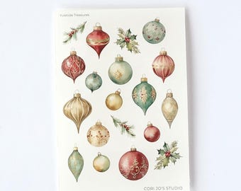 Op de afbeelding: Een transparant mat stickervel van 11,43 cm bij 16,51 cm met de titel Yuletide Treasures Stickers. Het vel bevat aquarelillustraties van diverse kerstballen in rood, goud en groen, samen met takjes hulst en dennennaalden.