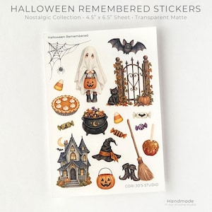 May include: A sticker sheet titled Halloween Remembered featuring illustrations of a ghost, a bat, a black cat, a haunted house, a cauldron, a witch hat, a broom, candy corn, a pumpkin, a spider web, and a pie on a 11.4 cm by 16.5 cm transparent matte sheet.