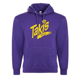 May include: A purple hoodie with a front pocket and a hood. The hoodie features the word "Takis" in yellow, with "FUEGO" underneath. The design is centered on the chest. The hoodie has long sleeves and a drawstring.