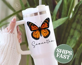 May include: White tumbler featuring a monarch butterfly design with orange and black wings. The name "Samantha" is written in cursive below the butterfly. A green circle with the words "SHIPS FAST" is on the right side.