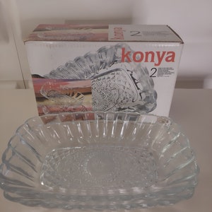 May include: Two clear glass serving dishes with a decorative pattern. The dishes are in a box with the word "konya" printed on it.