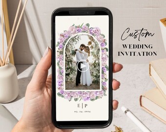 May include: A digital wedding invitation with a floral archway and a photo of a couple kissing. The invitation is displayed on a smartphone screen and includes the text "E|P" and "09.29.2024".