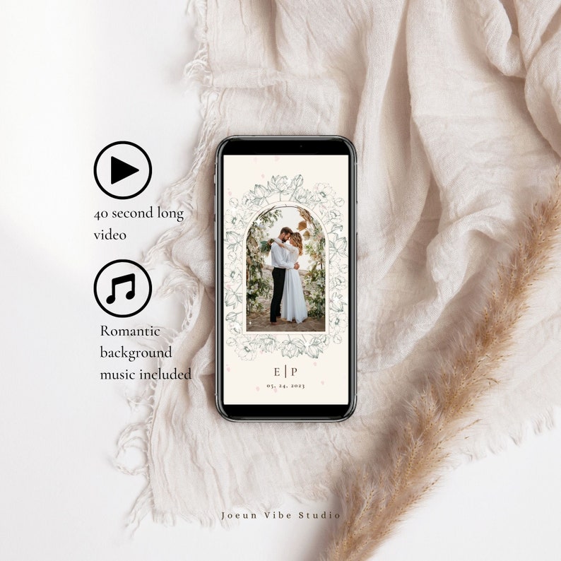 May include: A smartphone screen displaying a wedding invitation video with a floral archway design. The video is 40 seconds long and includes romantic background music. The text on the screen reads "E|P 05.28.2021".