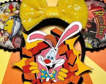 May include: A yellow sequined bow headband with Roger Rabbit character art. The headband features a large yellow bow and circular accents with Roger Rabbit breaking through a wall. The headband is a fun accessory.