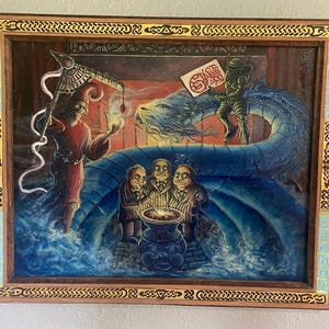 May include: A framed painting with a fantasy theme. The artwork depicts a robed figure holding a staff, a blue dragon, and several figures gathered around a glowing bowl. The frame is brown with decorative patterns and blue accents.