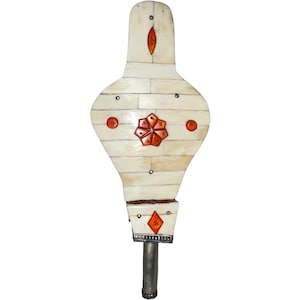 May include: A white bellows with a decorative design of red and white geometric shapes. The bellows is made of bone and has a silver metal handle.