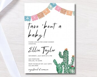 May include: A baby shower invitation with a colorful paper banner and a watercolor illustration of cacti. The text reads "Taco 'bout a baby!" and includes details about the event, including the date, time, location, and RSVP information. The invitation also includes the text "registered at amazon".