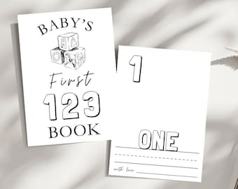 Könnte beinhalten: Schwarz-weißes druckbares Buchcover mit dem Text "BABY'S First 123 BOOK" und einer Zeichnung von drei gestapelten Blöcken. Das Cover enthält auch die Zahl "1" und das Wort "ONE" in großen, fetten Buchstaben.