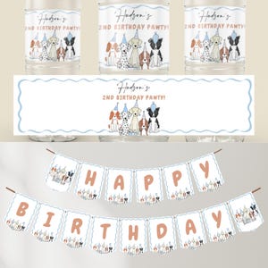 Peut inclure: Une banni&egrave;re blanche avec une bordure bleue et marron, avec les mots "HAPPY BIRTHDAY" en lettres marron. La banni&egrave;re est d&eacute;cor&eacute;e de chiens de dessin anim&eacute; portant des chapeaux de f&ecirc;te.