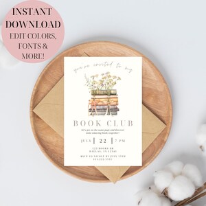 May include: A white invitation card with a watercolour illustration of a stack of books with flowers on top. The text on the card reads "You're invited to my Book Club. Let's get on the same page and discover some amazing books together! July 22 | 7 PM 123 Books Dr. Dallas, TX 12345 RSVP to Nicole by July 15th 111.222.5335"