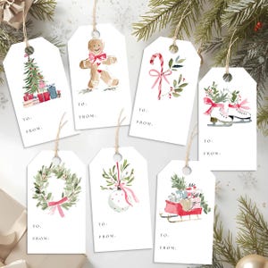 May include: Set of six white Christmas gift tags with watercolor illustrations. Designs include a Christmas tree, gingerbread man, candy cane, ice skates, wreath, ornament, and sleigh. Each tag has a string and space for "To:" and "From:"