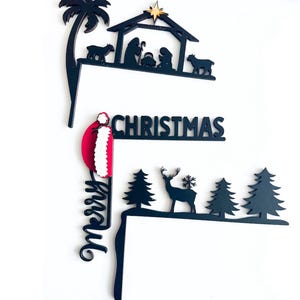 May include: Black metal Christmas yard sign featuring a nativity scene, a reindeer, and trees. The sign also includes the words "Merry Christmas".