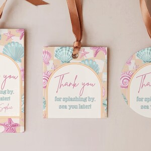 May include: Three gift tags with brown ribbon. The tags feature a seashell and starfish pattern in pastel colors. Each tag has the words "Thank you" and "for splashing by, see you later!"