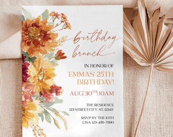 May include: A white invitation card with the text "birthday brunch" in a handwritten style. The card is decorated with watercolor flowers in shades of orange, yellow, and burgundy. The invitation is for Emma's 25th birthday.