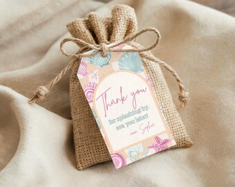 May include: A small burlap gift bag with a decorative tag. The tag features a seashell design in pastel colors and the words "Thank you" in pink script. The tag also includes the text "for splashing by, sea you later!" and a signature.