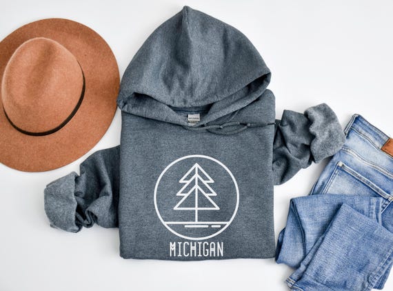 Dark Michigan hoodie with a simple white pine-tree design