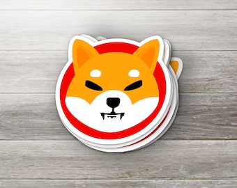 May include: A red and white sticker with a cartoon Shiba Inu dog with a black nose and eyes. The dog has a red tongue sticking out and is smiling.