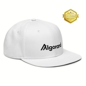 May include: White baseball cap with the word "Algorand" in black, embroidered on the front. The cap has a flat brim and a structured fit. A gold "Exclusive High Quality Best Choice" badge is on the upper right.