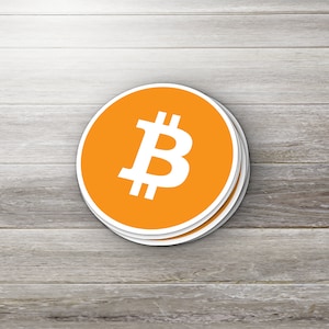 May include: A stack of round orange stickers with a white Bitcoin symbol in the center.