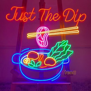 May include: Neon sign with the text "Just The Dip" in orange, a pink and yellow illustration of chopsticks dipping a piece of meat into a blue bowl of hot pot with green vegetables and mushrooms, and the text "Arttena" in purple.