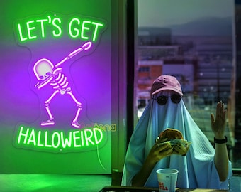 May include: A neon sign with the words "LET'S GET HALLOWEIRD" and a skeleton dabbing. A person dressed as a ghost wearing sunglasses and a pink cap is holding a burger and a drink. A tray with food is on the table.