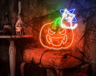 May include: A neon sign featuring a jack-o'-lantern with a cute cat wearing a witch's hat on top. The neon sign is orange, green, and blue.