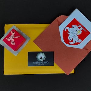 The packaging of the jewelry includes a red box, on the lid of which is a bow with Belarusian ornament, as well as an envelope, which contains a postcard with the coat of arms "Pogonya", and in the envelope is a business card.