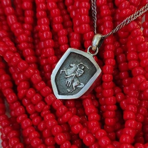 oxidized silver pendant with the coat of arms "The Chase", the national symbol of Belarus, Lithuania. The coat of arms depicts a knight on horseback, the knight is holding a sword and shield