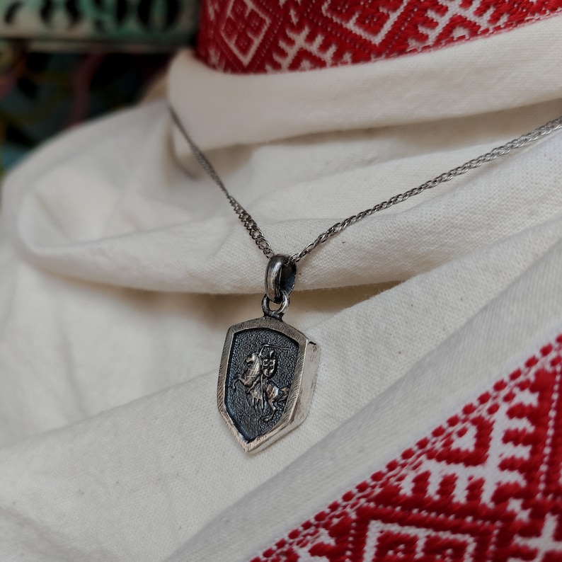 oxidized silver pendant with the coat of arms "The Chase", the national symbol of Belarus, Lithuania. The coat of arms depicts a knight on horseback, the knight is holding a sword and shield