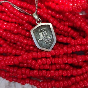 oxidized silver pendant with the coat of arms "The Chase", the national symbol of Belarus, Lithuania. The coat of arms depicts a knight on horseback, the knight is holding a sword and shield