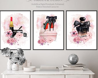 May include: Three framed wall art prints featuring watercolor illustrations. The left print shows lipstick, mascara, and pink flowers. The center print displays a high-heeled shoe on a box. The right print depicts a perfume bottle with a black bow.