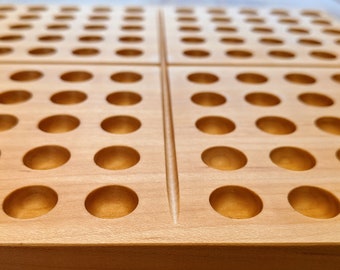 May include: A wooden board with a grid of 100 round holes, perfect for playing a game of peg solitaire.