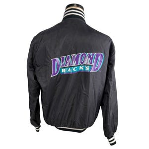 May include: Black satin jacket with the Diamondbacks logo in purple and teal. The jacket has a white, black, and gray striped collar and cuffs. The jacket is a vintage style.