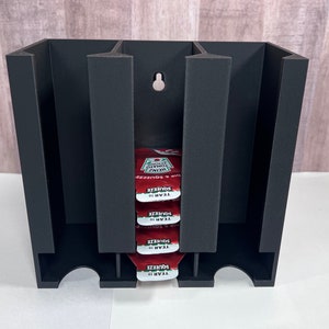 Heinz ketchup single serve holder dispenser holds about 24-27 and is wall mountable.